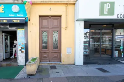 a brown door on the side of a building at #35 Suite Carlone 5min from the beach AC & Terrace in Nice