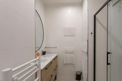 a white bathroom with a sink and a mirror at #35 Suite Carlone 5min from the beach AC & Terrace in Nice