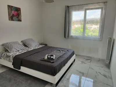 a bedroom with a bed with a tray on it at Spacieux 3 chambres et balcon in Nice