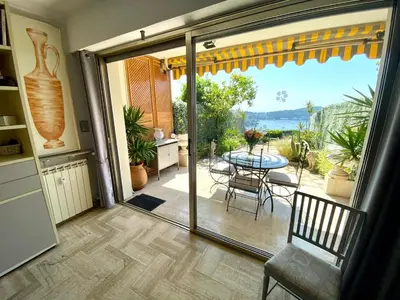 a sliding glass door leading to a patio with a table at Studio Bellevue in Villefranche-sur-Mer