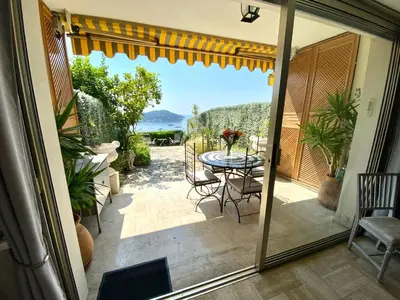 a view of a patio with a table and chairs at Studio Bellevue in Villefranche-sur-Mer