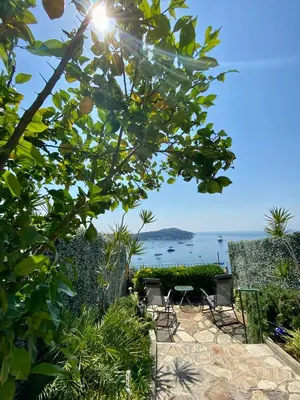 a patio with chairs and a view of the ocean at Studio Bellevue in Villefranche-sur-Mer