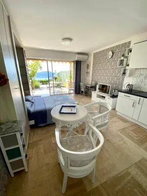 a bedroom with a bed and a table in a room at Studio Bellevue in Villefranche-sur-Mer