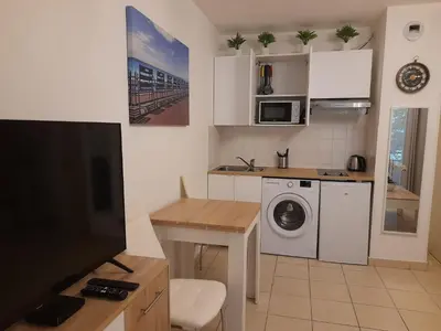 a small kitchen with a washer and dryer at Sunny studio with Terrace in Nice
