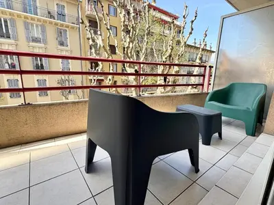 a balcony with a chair and a piano on a building at Sunny studio with Terrace in Nice