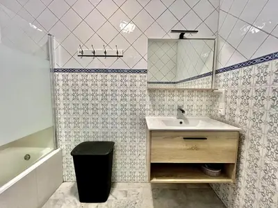 a bathroom with a sink and a mirror and a tub at Spacious 2P Terrace with sea view in Nice