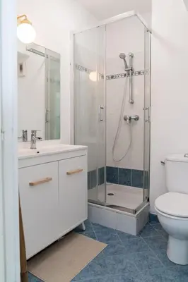 a white bathroom with a shower and a toilet at Studio équipé dans une résidence avec piscine à 10mn du centre ville in Nice