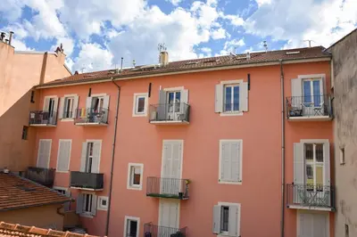 an orange building with white windows and balconies at Charmant studio moderne équipé à Nice in Nice