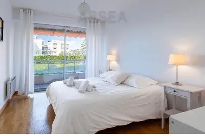 a white bedroom with a large bed and a window at Nice Absea Belles Terres A in Nice