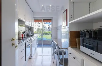 a large kitchen with white cabinets and a large window at Nice Absea Belles Terres A in Nice