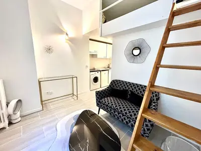 a living room with a ladder and a couch at City Center Studio - 1 min Train Station & Main Street in Nice