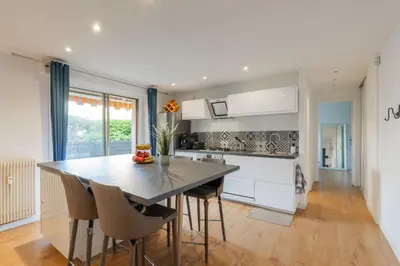 a kitchen with a table and chairs in a room at Grand 2 pieces et belle terrasse ensoleillee in Nice