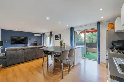 a kitchen and living room with a table and a couch at Grand 2 pieces et belle terrasse ensoleillee in Nice