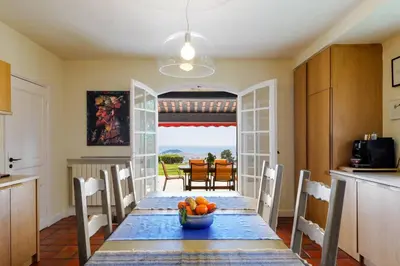 a kitchen with a table with a bowl of fruit on it at Magnifique villa avec vue mer panoramique in Nice