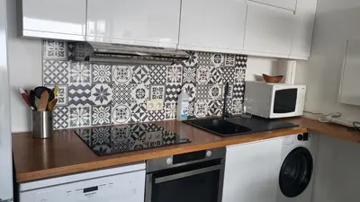 a kitchen with a counter top with a microwave at Costa Plana apartment with terrace and sea view in Cap d'Ail