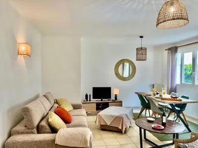 a living room with a couch and a table at Les Bleuets in Cagnes-sur-Mer