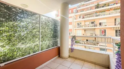 a balcony with a large window in a building at nice two rooms in Nice