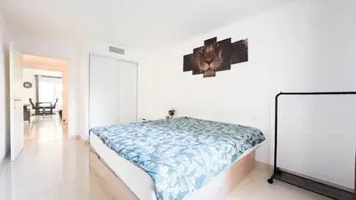 a bedroom with a bed in a white room at nice two rooms in Nice