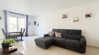 a living room with a couch and a table at nice two rooms in Nice