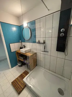 a bathroom with a tub and a sink and a mirror at Agréable appartement à Beaulieu sur mer à 300 métres des commerces et de la mer in Beaulieu-sur-Mer