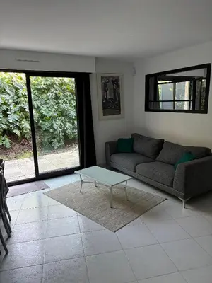 a living room with a couch and a coffee table at Agréable appartement à Beaulieu sur mer à 300 métres des commerces et de la mer in Beaulieu-sur-Mer