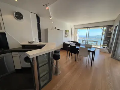 a kitchen and dining room with a table and chairs at Les Jardins de Villefranche in Villefranche-sur-Mer