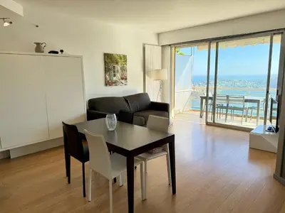 a living room with a table and a couch at Les Jardins de Villefranche in Villefranche-sur-Mer