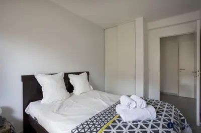 a bedroom with a bed with towels on it at Air-conditioned apartment near Libération district in Nice
