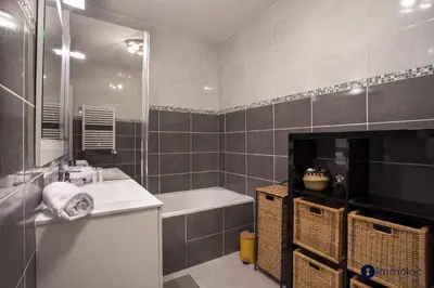 a bathroom with a sink and a tub and a bath tub at Air-conditioned apartment near Libération district in Nice