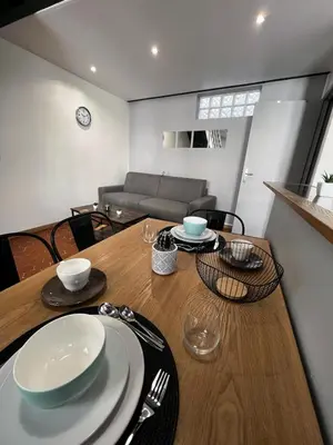 a dining room with a table and a couch at Central Super Loft in Nice