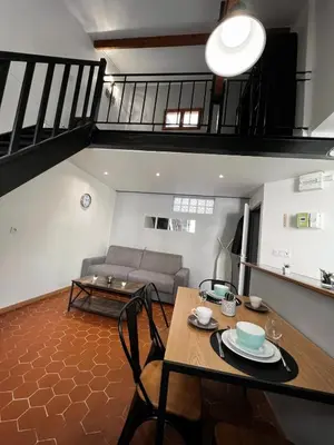 a living room with a table and a couch at Central Super Loft in Nice