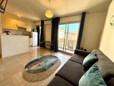 a living room with a couch and a glass table at Cozy Apt with balcony - Garibaldi Port in Nice