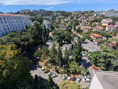 an aerial view of a city with cars parked in a parking lot at Appartement SEA-Azur panorama Nice Fabron in Nice