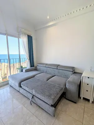 a bedroom with a large couch and a large window at Appartement SEA-Azur panorama Nice Fabron in Nice