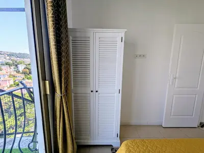 a bedroom with a balcony with a white closet at Appartement SEA-Azur panorama Nice Fabron in Nice