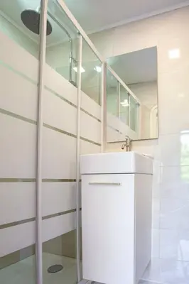 a bathroom with a sink and a mirror at LYMPIA -Cosy studio, 200 m plages de Nice - Le Port in Nice