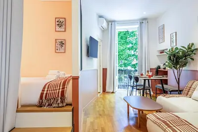 a bedroom and a living room with a bed and a table at New! Remodeled Appartement in the Heart of Nice, Beach 3 min, 2BR, AC, Elevator, Amazing little terrace, Best Location! in Nice