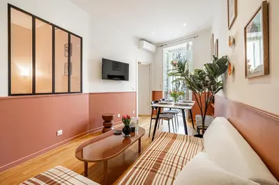 a living room with a couch and a table at New! Remodeled Appartement in the Heart of Nice, Beach 3 min, 2BR, AC, Elevator, Amazing little terrace, Best Location! in Nice