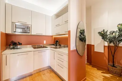a kitchen with white cabinets and a sink at New! Remodeled Appartement in the Heart of Nice, Beach 3 min, 2BR, AC, Elevator, Amazing little terrace, Best Location! in Nice
