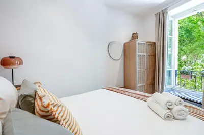 a bedroom with a bed and a window at New! Remodeled Appartement in the Heart of Nice, Beach 3 min, 2BR, AC, Elevator, Amazing little terrace, Best Location! in Nice