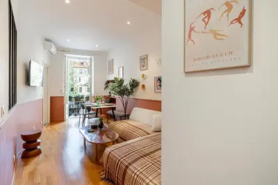 a living room with a bed and a table at New! Remodeled Appartement in the Heart of Nice, Beach 3 min, 2BR, AC, Elevator, Amazing little terrace, Best Location! in Nice