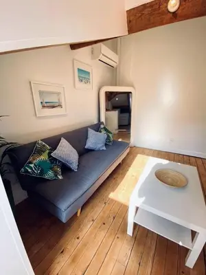 a living room with a blue couch and a table at Guisol 17 Attic cocon Port de Nice in Nice