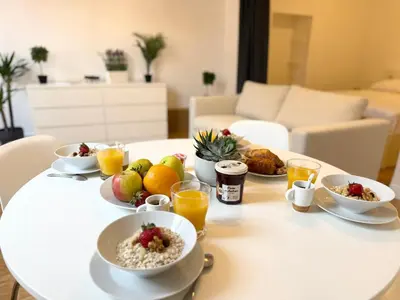 a white table with bowls of breakfast food on it at Charmant 2 pièces proche mer in Nice