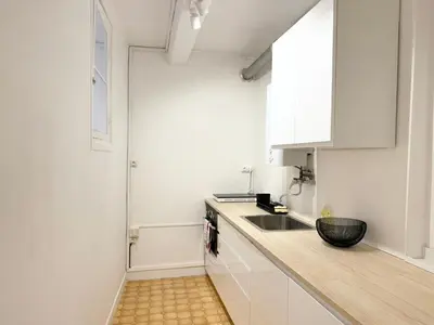 a kitchen with a sink and a counter top at Charmant 2 pièces proche mer in Nice