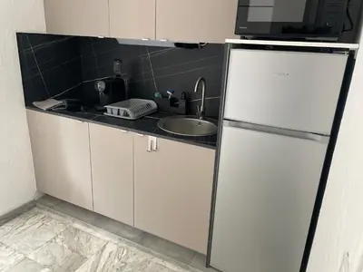 a kitchen with a refrigerator and a sink at Studio 100m plage in Cagnes-sur-Mer
