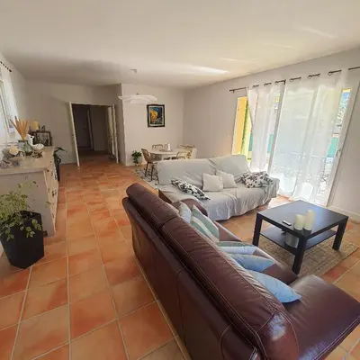 a living room with a couch and a table at Le flamand in Tourrette-Levens