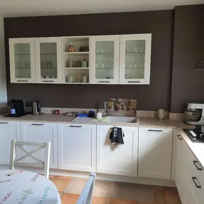 a kitchen with white cabinets and a counter top at Le flamand in Tourrette-Levens