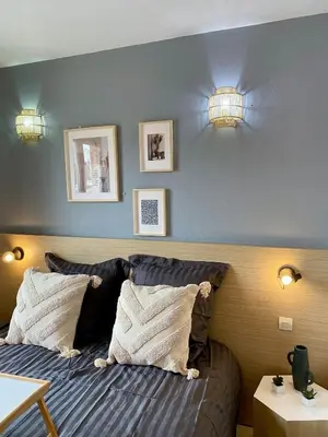 a bedroom with a bed with two pillows at Charming studio with swimming pool in Nice
