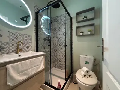 a bathroom with a shower and a toilet and a sink at Studio 2 Libération proche tram in Nice