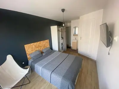 a bedroom with a bed and a television in it at Appartement de 4 chambres proche plage, tram et aeroport in Nice